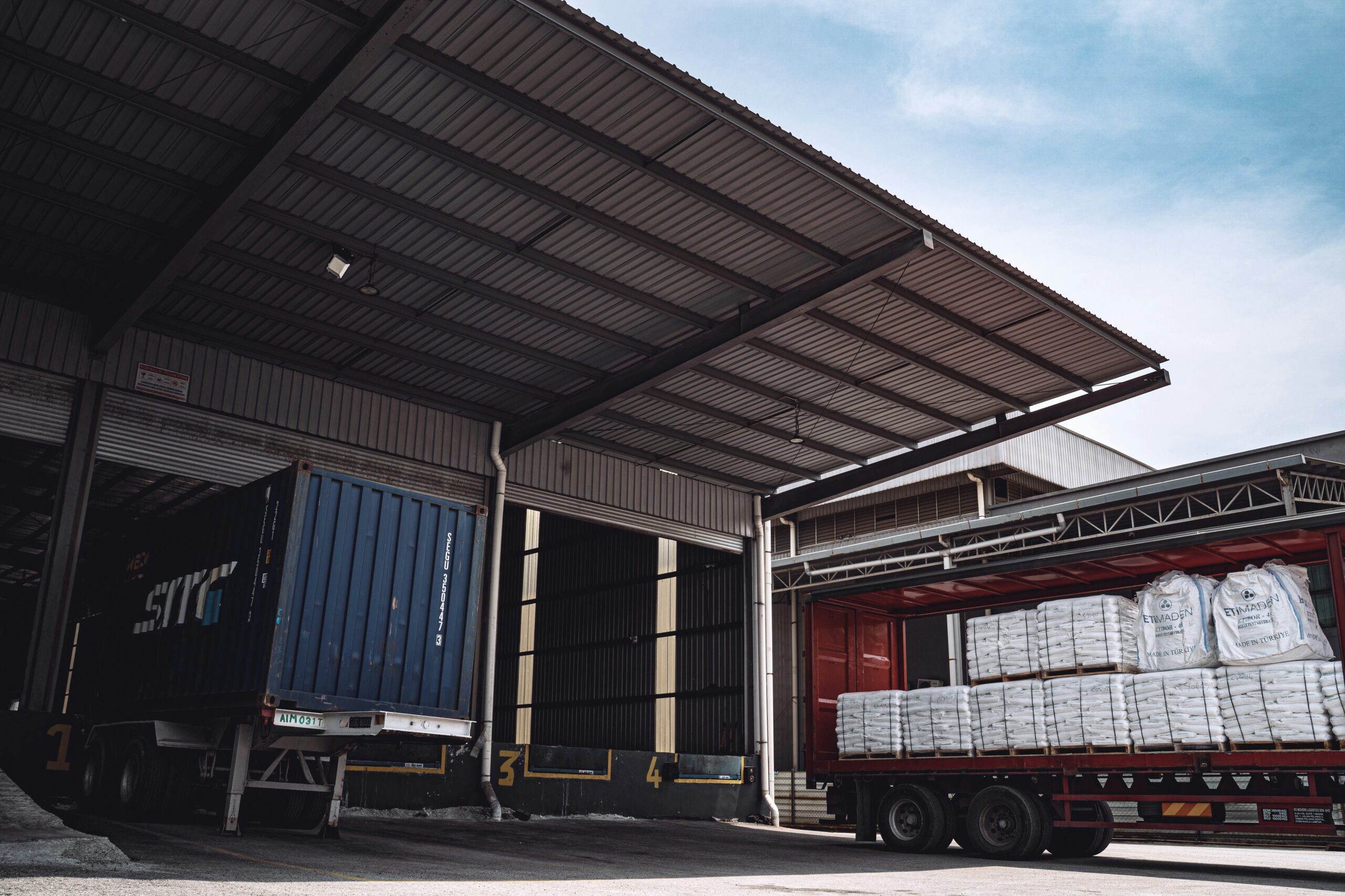 Lorries parked in a loading bay.