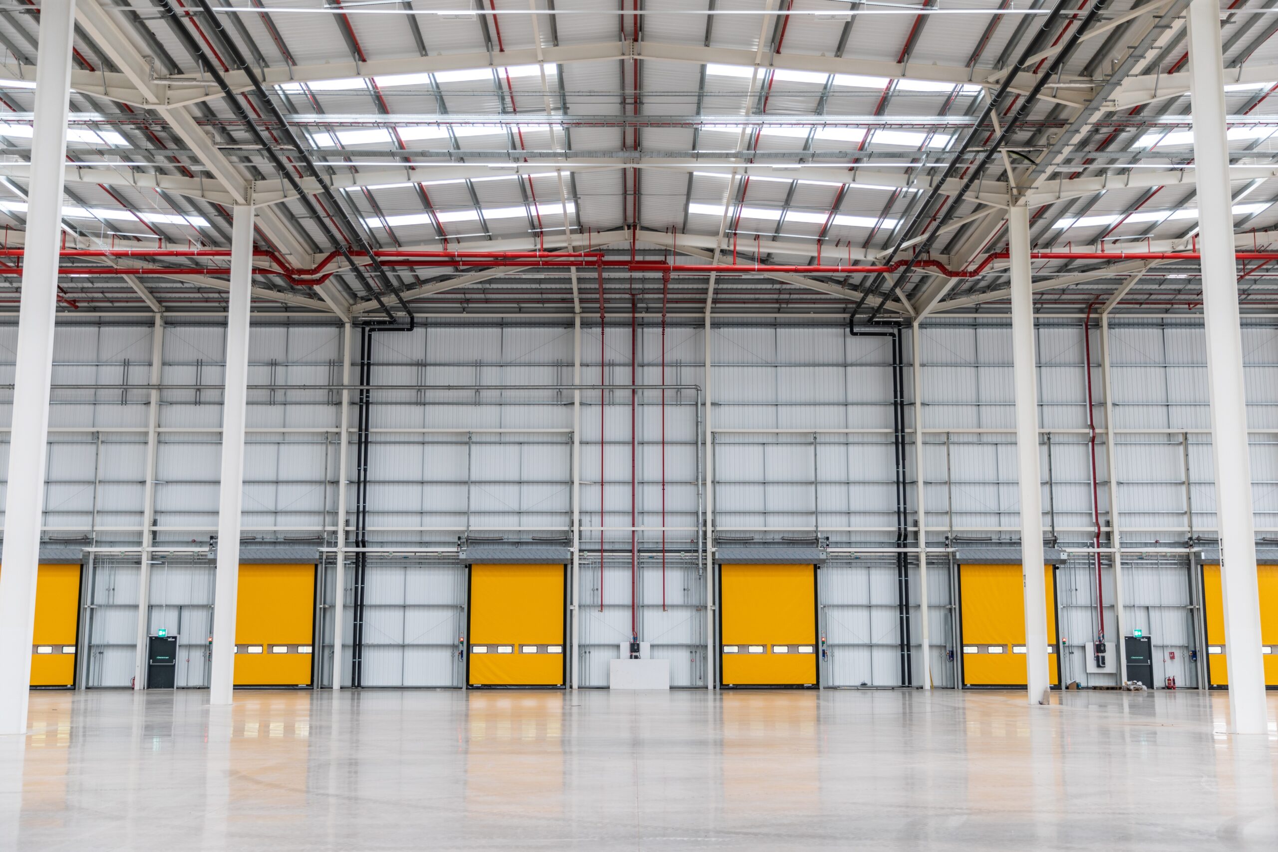 Six yellow high speed doors that have been implemented into a warehouse by RDS.